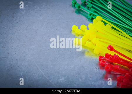 Set of plastic cable ties on scratched metallic background. Stock Photo