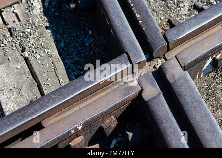 Close up for junction of railway rails on the tracks. Photo taken during the day with good lighting Stock Photo