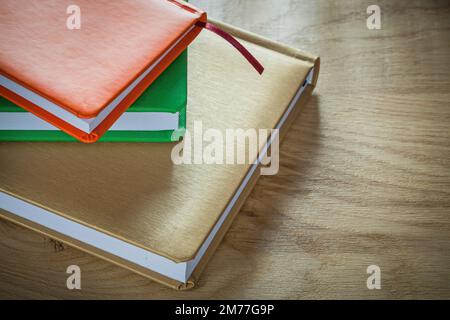 Stack of office notebooks on wooden board. Stock Photo