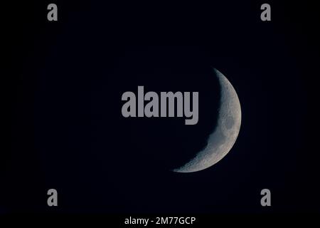 Close-up horizontal view of a new moon in a black sky in detail Stock Photo