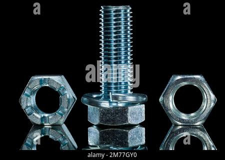 Threaded construction crown nut screwbolt bolt washer on black background. Stock Photo