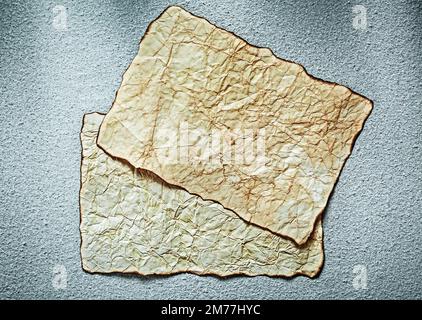 Vintage blank sheets of paper on grey background. Stock Photo