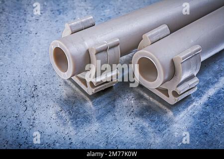 Water-pipes pipe clamps on metallic background construction concept. Stock Photo