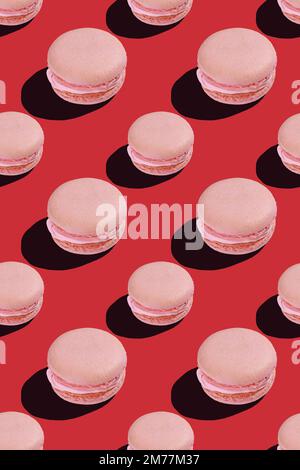 seamless pattern of pink macaroon cookies on red background  Stock Photo