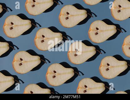 seamless pattern of fresh half of pear with shadow on blue background  Stock Photo