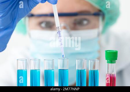 Cropped shot of an attractive young female scientist using a pipette to fill up test tubes in her laboratory Stock Photo