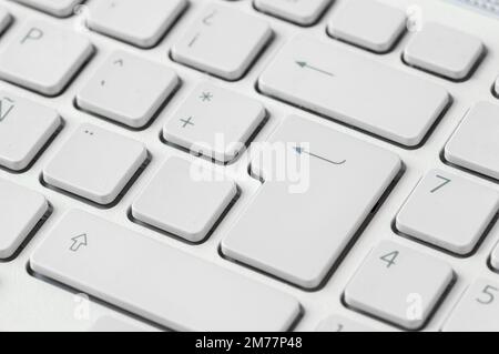 Close-up of a computer keyboard with focus on the enter key. Stock Photo
