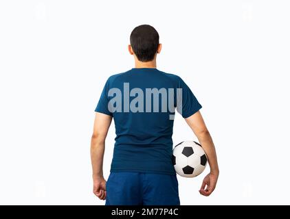 Cropped rearview image of a young player man holding a soccer ball under his arms at Paris.Rearview Stock Photo