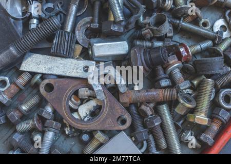 Top view of bolts and other mechanic tools. Rusty and new tools. Top view. Concept of car mechanic tools, industrial. Stock Photo