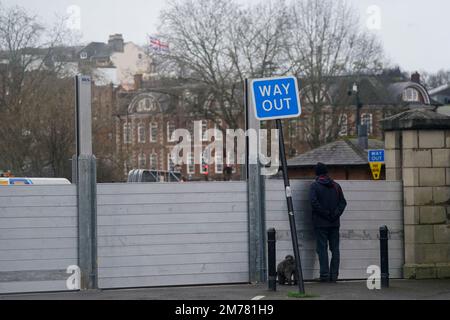 A man walking his dog observes flood defences at Frankwell car park in Shrewsbury, which has been closed due to it's proximity to the river Severn. The Environment Agency (EA) has two flood warnings in place in the town. Picture date: Sunday January 8, 2023. Stock Photo