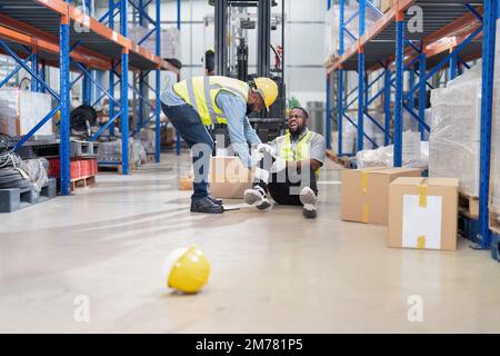 African american working in warehouse got accident from carry box, forklift truck working near by Stock Photo