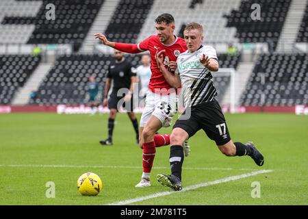 Matty Wolfe #33 of Barnsley and Louie Sibley #17 of Derby County battles for the ball during the Emirates FA Cup Third Round match Derby County vs Barnsley at Pride Park Stadium, Derby, United Kingdom, 8th January 2023  (Photo by Mark Cosgrove/News Images) Stock Photo