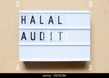 Lightbox with word halal audit on wood background Stock Photo