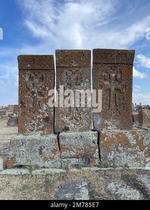 A vertical shot of ancient khachkars in the historical cemetery of Noratus in Armenia Stock Photo