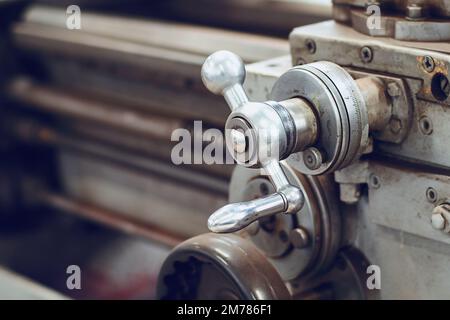 Old lathe for metal processing. Type of metal machine parts in lathe shop at factory. Industrial background. Industrial equipment.. Stock Photo