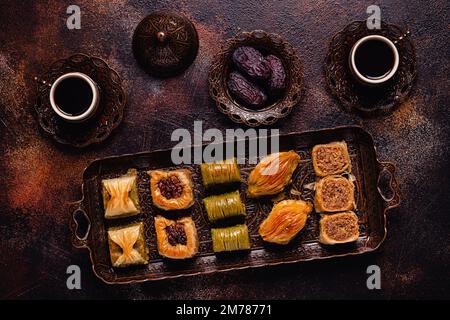 Traditional turkish, arabic sweets baklava assortment with Turkish coffee. Stock Photo