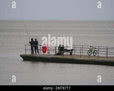 Sheerness, Kent, UK. 8th Jan, 2023. UK Weather: an overcast and windy afternoon Sheerness, Kent. People fish from Neptune Jetty. Credit: James Bell/Alamy Live News Stock Photo