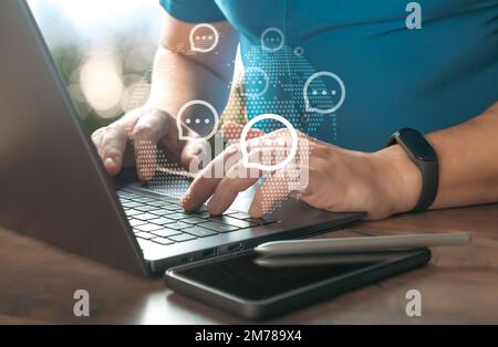 Man working and typing on laptop with sending message icons. Live chat chatting and social network concepts, Close-up hands typing on keyboard laptop Stock Photo