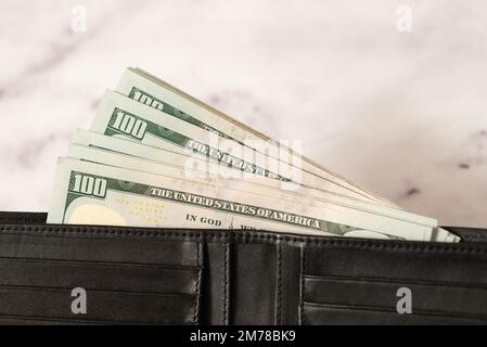 banknote money dollars in a wallet on a light background, the concept of saving money and business growth, the concept of finance and investment Stock Photo