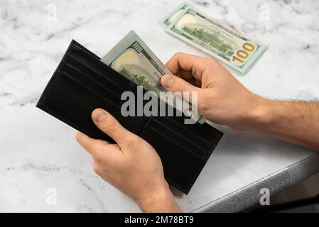 banknote money dollars in a wallet on a light background, the concept of saving money and business growth, the concept of finance and investment Stock Photo