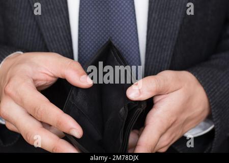 Close up of man hands holding and empty wallet Stock Photo