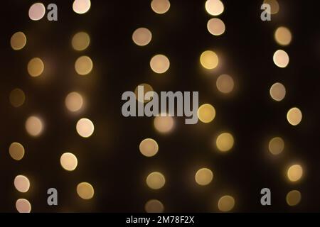Dark background with sparkling dots. Illuminated wallpaper. Digital illustration. Shiny golden circles in darkness. Festive glitter. Diamonds in night. Stock Photo
