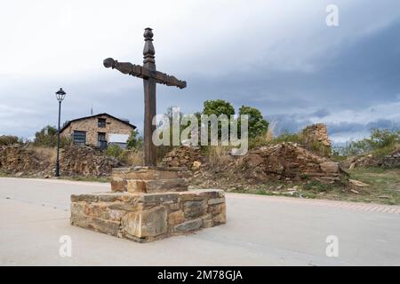 A rustic wooden cross greets visitors entering the village of Foncebadón along the Camino Frances in León, Spain. This ancient route of the Way of St. Stock Photo