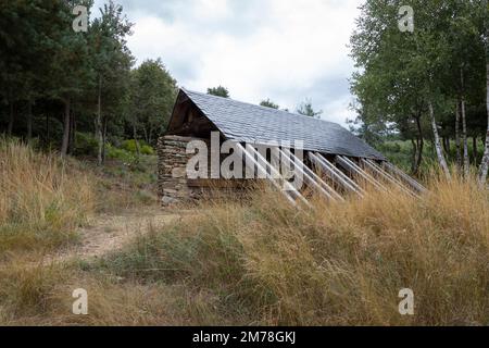 A rustic modern rest stop provides shelter and water for pilgrims along the Camino Frances near the village of Rabanal del Camino in León, Spain. This Stock Photo