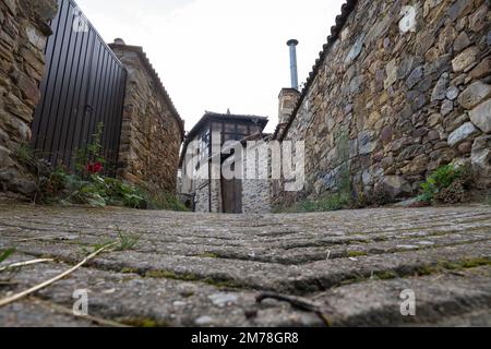 A narrow alleyway in the village of Rabanal del Camino along the Camino Frances in Leon, Spain. This ancient route of the Way of St. James pilgrimage Stock Photo