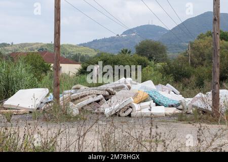 Large group of used dirty sleeping mattresses. Abandoned in wild landfill Stock Photo