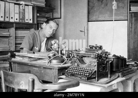 Cluttered Small Business 1940s Office with Underwood Standard Typewriter No 5 and Vintage Telephone with Cupboards and Filing Cabinets France 1945 Stock Photo