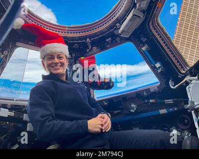 International Space Station, EARTH ORBIT. 24 December, 2022. NASA Expedition 68 NASA Flight Engineer, Nicole Mann, poses for a holiday portrait with her Christmas stocking on Christmas Eve inside the cupola of the International Space Station, December 25, 2022 in Earth Orbit. Mann, is the first Native American astronaut in space and the first to command a mission. Stock Photo