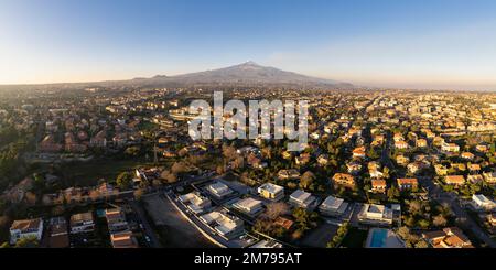 Aerial view - Mount Etna Volcano and Catania city, Sicily island, Italy (Sicilia, Italia) Snow-covered craters, Etna in activity and summit craters Stock Photo