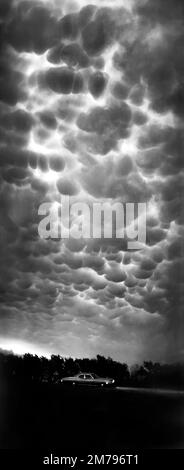 Mammatus clouds or mammatocumulus cloud at night over a classic Chevrolet touring car on highway 41 north of Velva, North Dakota.  Severe thunderstorm Stock Photo