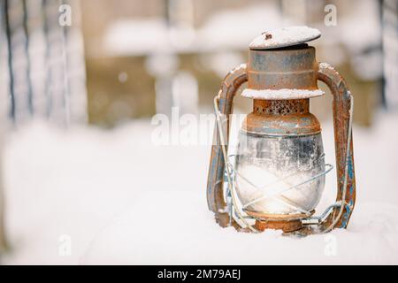 Old railroad lantern in the winter snow with room for copy Stock Photo