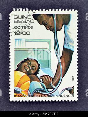 Cancelled postage stamp printed by Guinea Bissau, that shows Healthcare, celebrating 11th Anniversary of Independence, circa 1984. Stock Photo