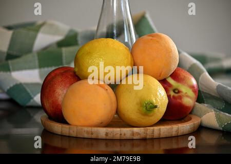 Peaches and lemons on the table Stock Photo