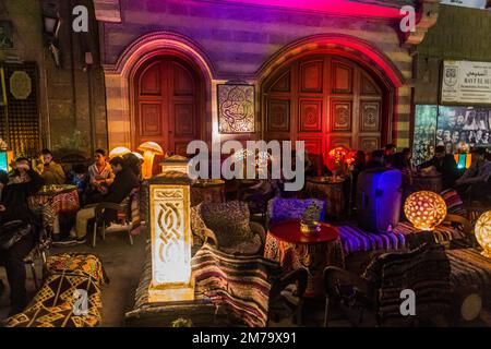 CAIRO, EGYPT - JANUARY 26, 2019: Evening view of a cafe at Al Moez street in the historic center of Cairo, Egypt Stock Photo