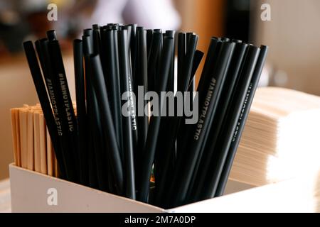 Natural eco-friendly disposable paper straws in coffee shop on wooden background with copy space. Save the earth, waste reduction concept. Stock Photo