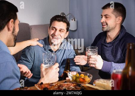 Friendly meeting in men company over beer with pizza Stock Photo