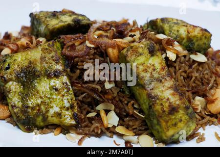 moroccan style chermoula samak, traditional arabic middle eastern flavored rice with spice marinated grilled fish Stock Photo