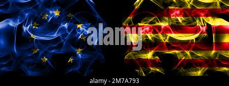 Flags of EU, European Union vs Spain, Catalonia, Catalan, Senyera. Smoke flag placed side by side on black background. Stock Photo