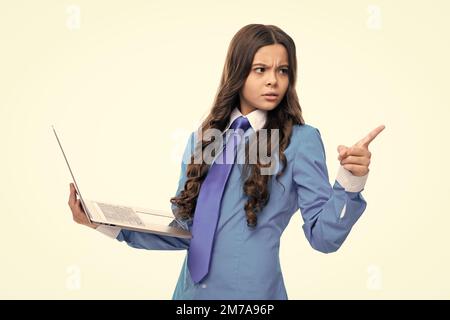 Young girl student hold computer. Funny pupil with laptop isolated on white background. Back to school. Stock Photo