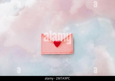 Felt envelope with red heart for Valentine day on colorful background, top view Stock Photo