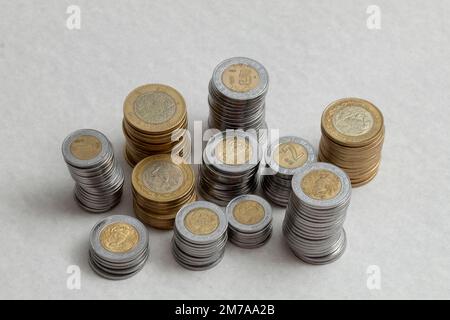 Mexican pesos coins stacked by denominations , on a table. Stock Photo