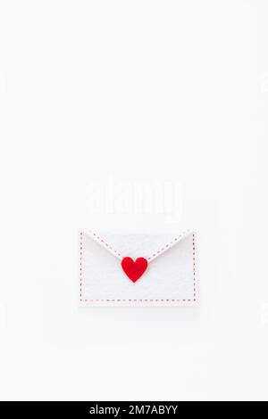 Felt envelope with red heart on white background Stock Photo