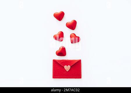 Red felt envelope with hearts on white background Stock Photo