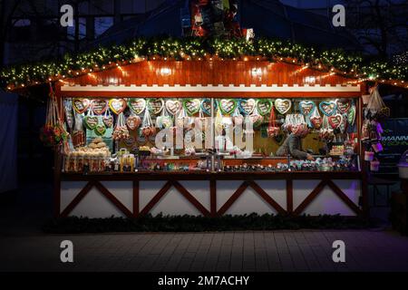 Picture of stands selling gingerbread and sweets in Duisburg Christmas market, also called weihnachtsmarkt, in winter, in Germany. Stock Photo