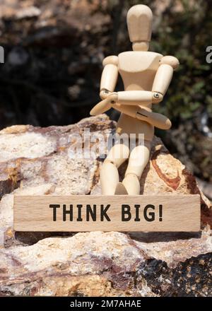 Think big is written on the wooden surface. Wooden Concept. Stock Photo