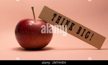 Think big is written on the wooden surface. Wooden Concept. Stock Photo